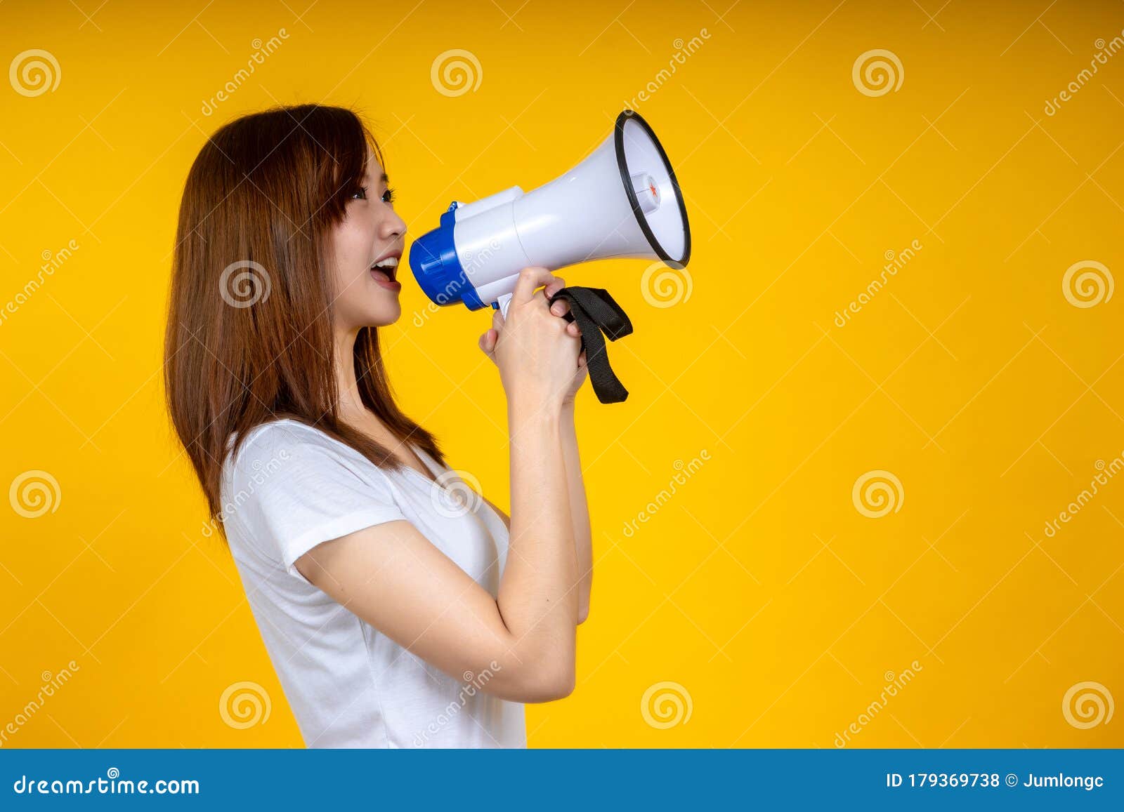 young asian woman in white casual t-shirt looking aside, scream in megaphone  on bright yellow