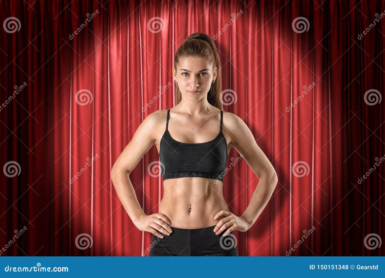 Young Athletic Brunette Girl in Black Sport Clothing with Hands on Hips on  Red Stage Curtains Background Stock Photo - Image of confident, muscular:  150151348