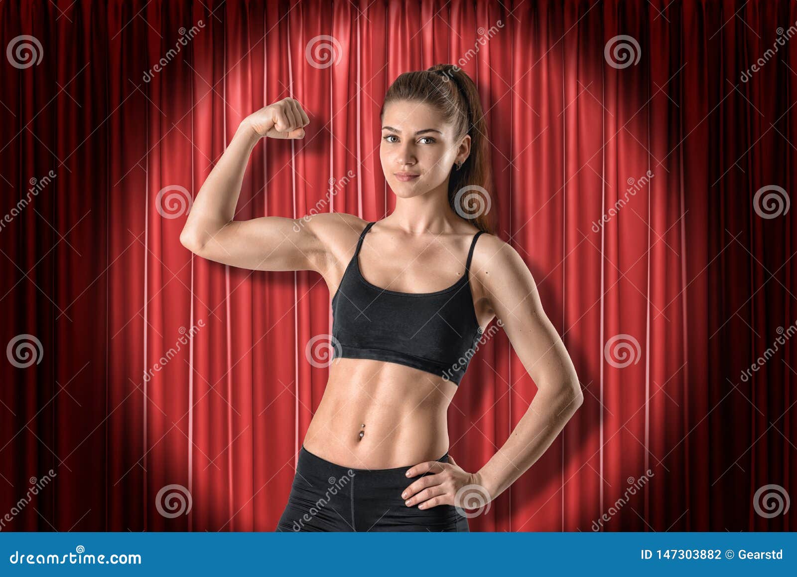 Young Athletic Girl in Black Sport Clothing Showing Biceps on Red Stage  Curtains Background Stock Photo - Image of lifestyle, serious: 147303882