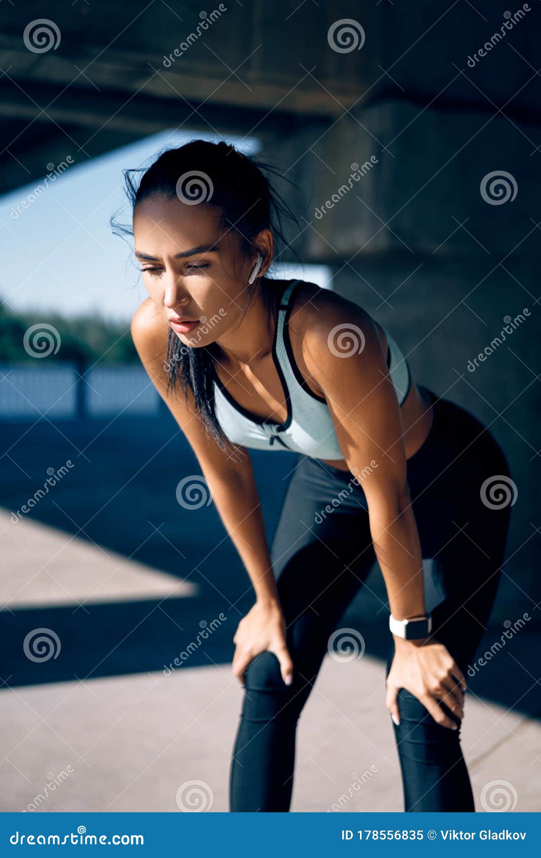 Young Athletic Woman Feeling Exhausted and Taking a Break while Running ...