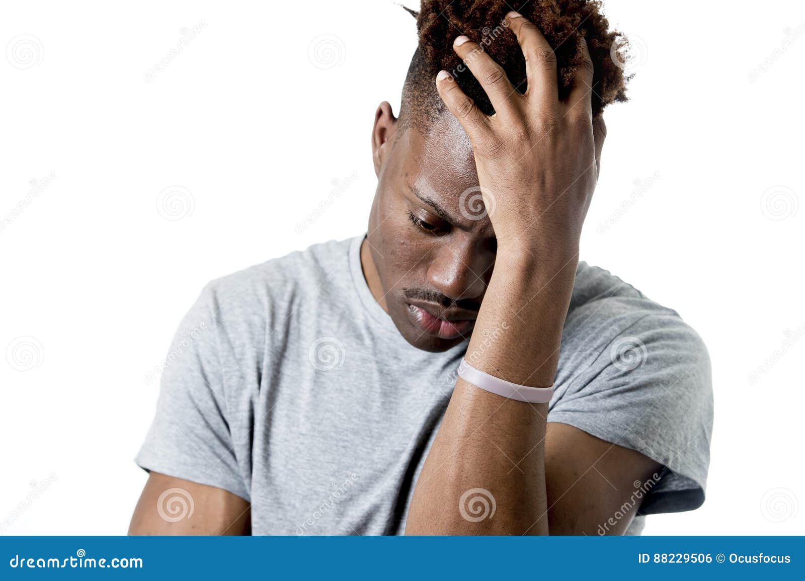 young attractive afro american man on his 20s looking sad and depressed posing emotional