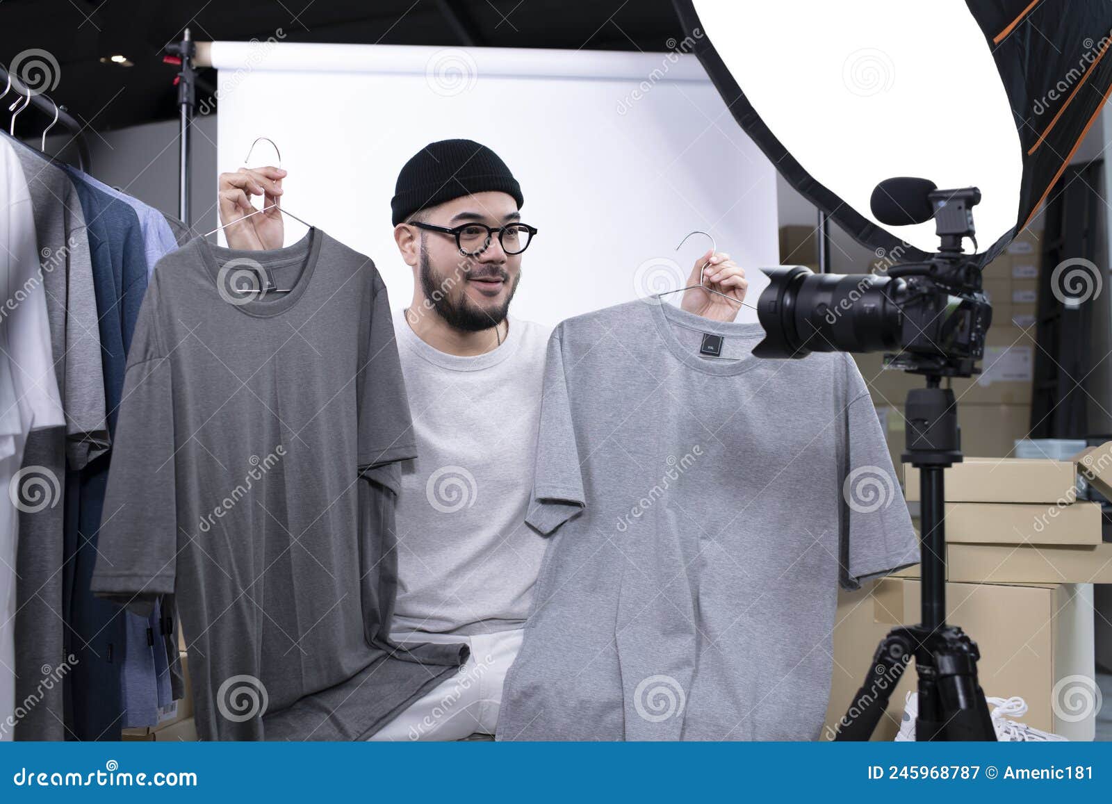 asian man blogger or vlogger looking at camera reviewing product