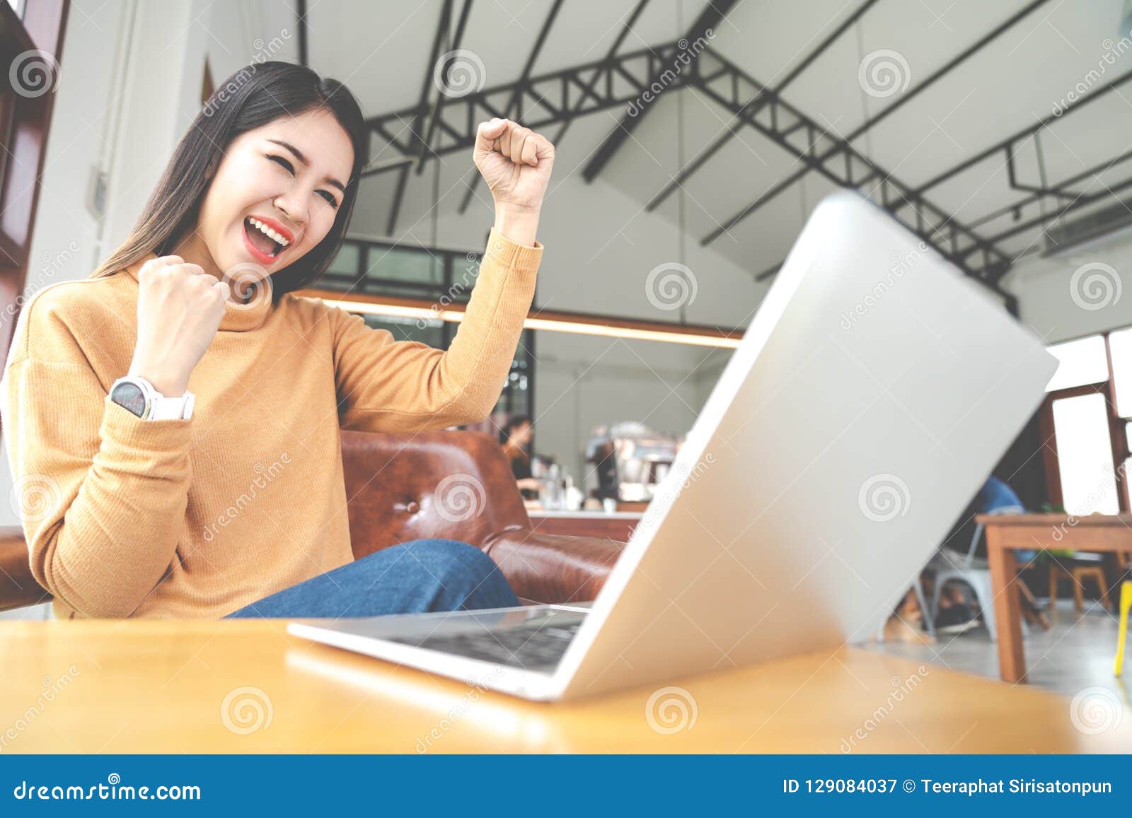 young attractive asian woman looking at laptop computer feeling happy cheerful or excited expression success or win