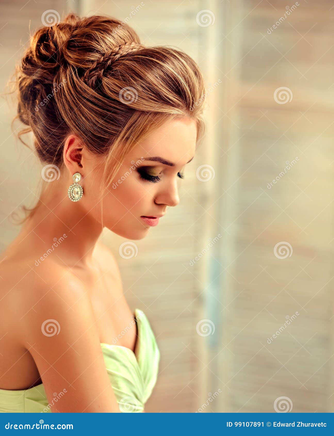 Beautiful young woman in gorgeous black evening dress with perfect makeup  and hair style Stock Photo by ©cherry_daria 130759974