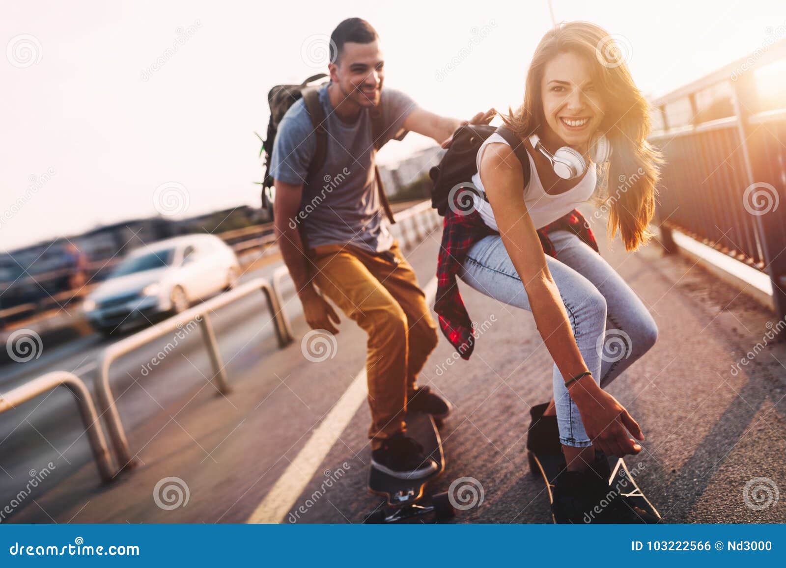 Young Attractive Couple Riding Skateboards And Having Fun