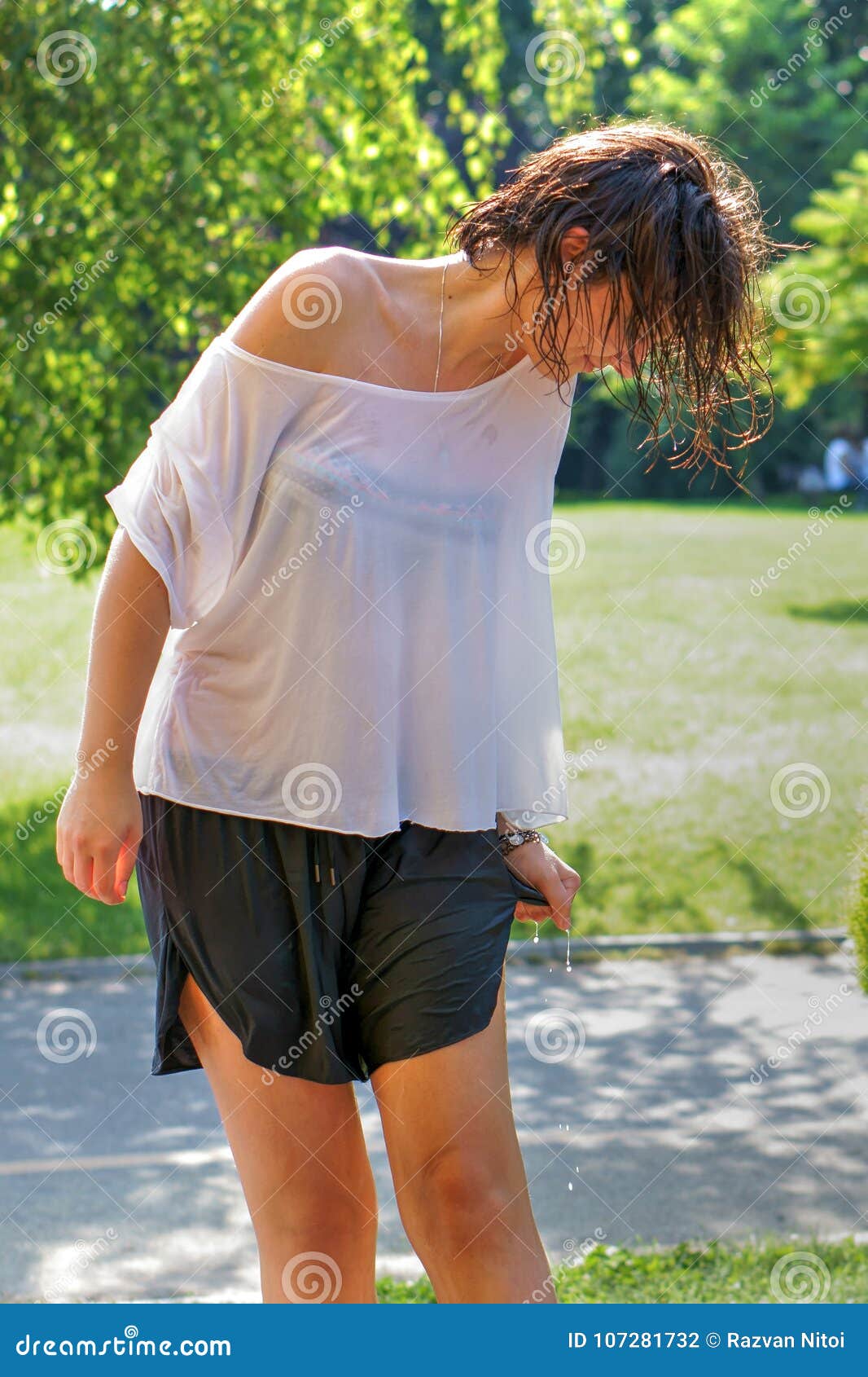 Young Attractive Female With Soaking Wet Clothes And Hair Editorial