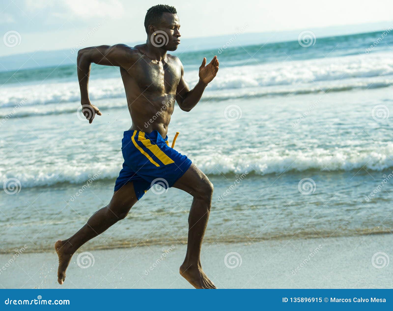 Young Attractive Fit Athletic and Strong Black African American Man Running at the Beach Training Hard and Sprinting on Sea Water Stock Image pic picture