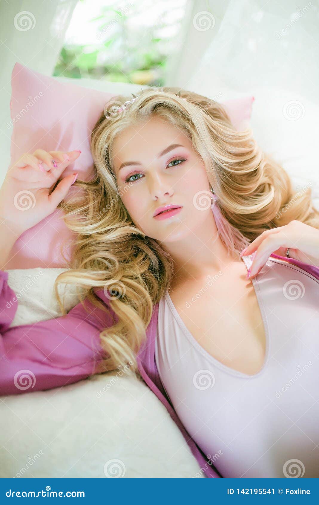 Young Attractive Girl with Curly Long Blond Hair in Pink Negligee Stock ...