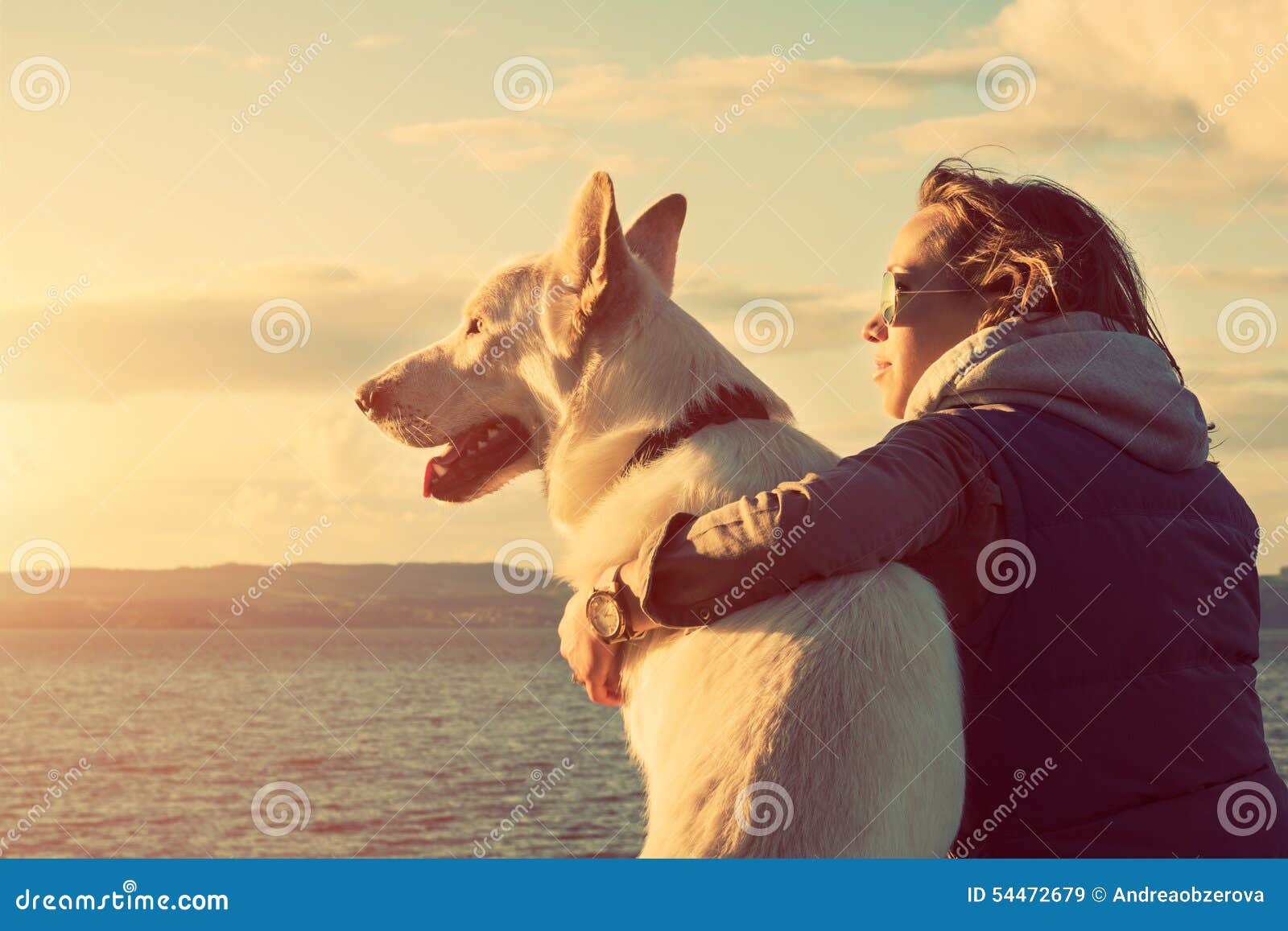 young attractive girl with her pet dog at a beach