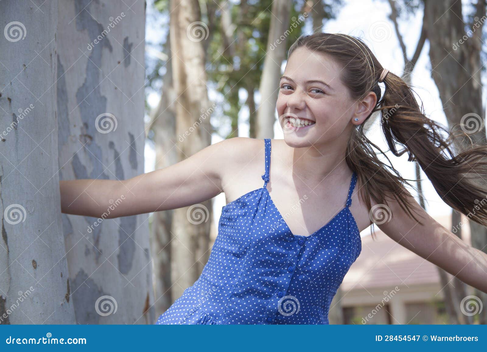 A Young Attractive Girl Playing Hide And Seek In The Woods S