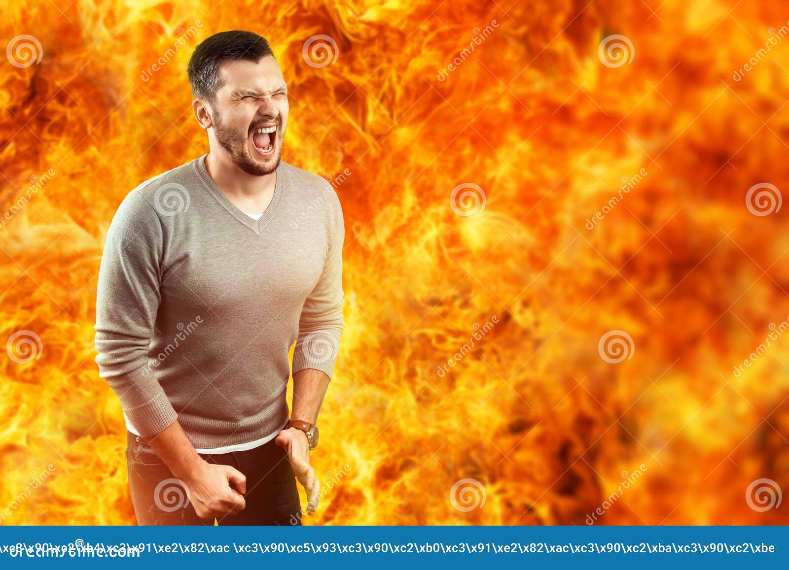a young attractive man feels pain in a flame, surrounded by hot fire. he feels hate, anger, anger, envy