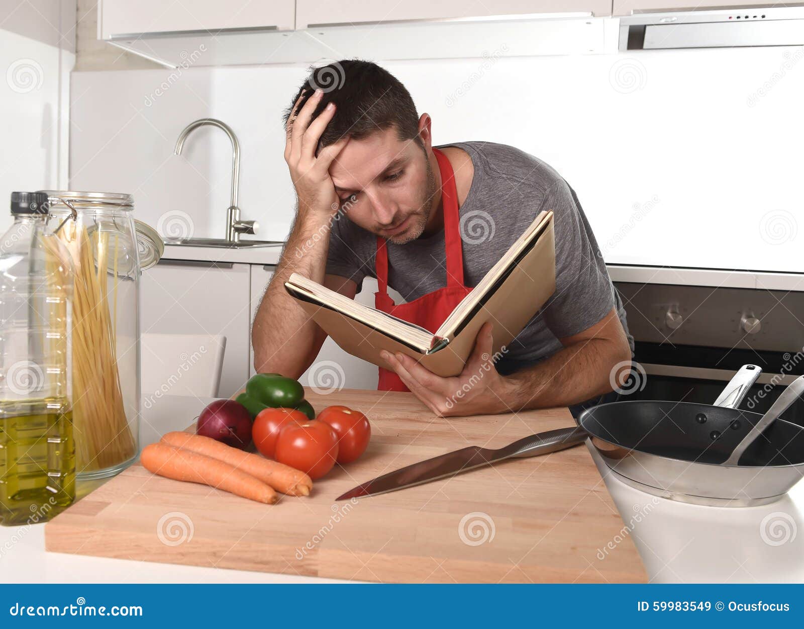 Young Attractive Man At Home Kitchen Reading Recipe Book In Stress