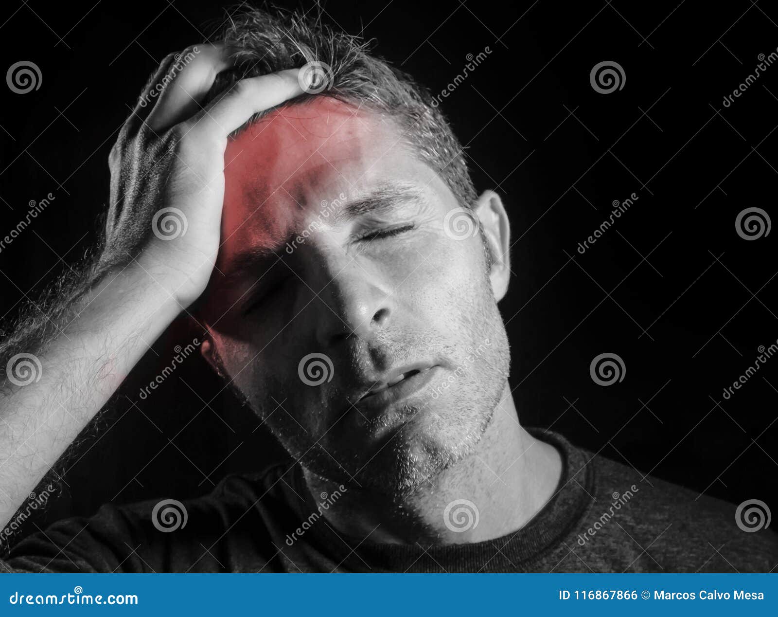 young attractive and sad man suffering headache with hand on his tempo head in stress looking desperate and sick  black a