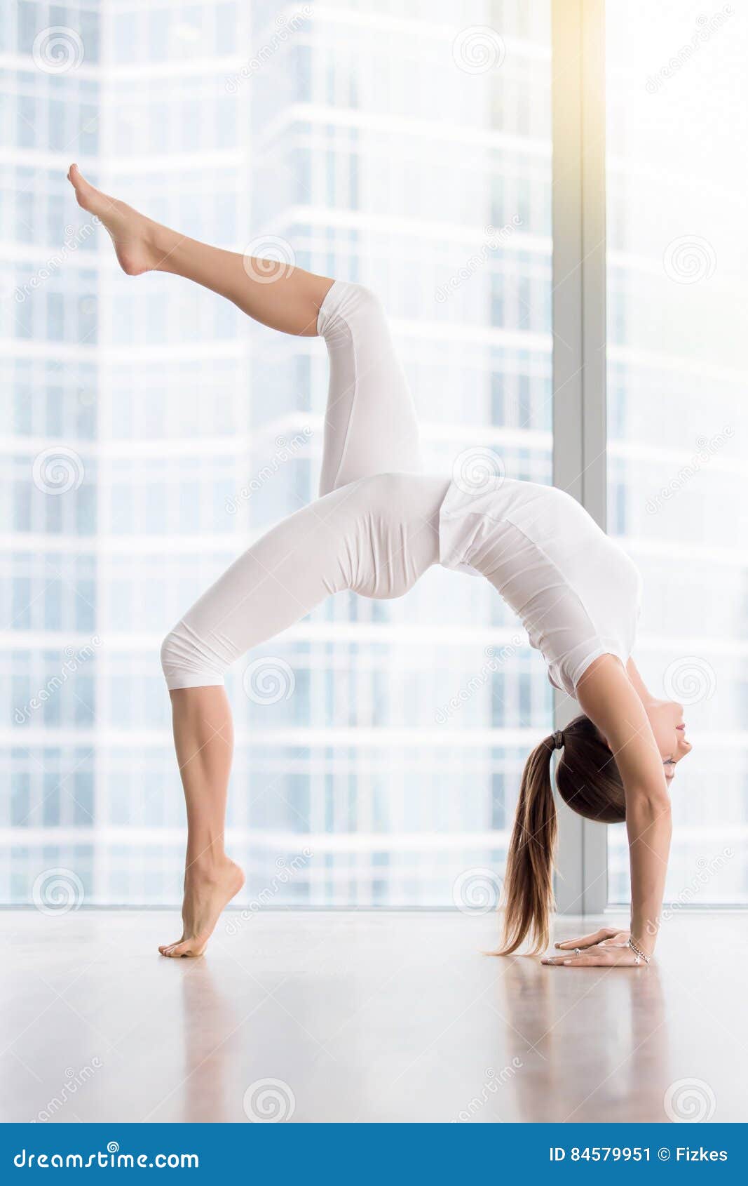 Young happy mother working out, doing butt bridge exercise