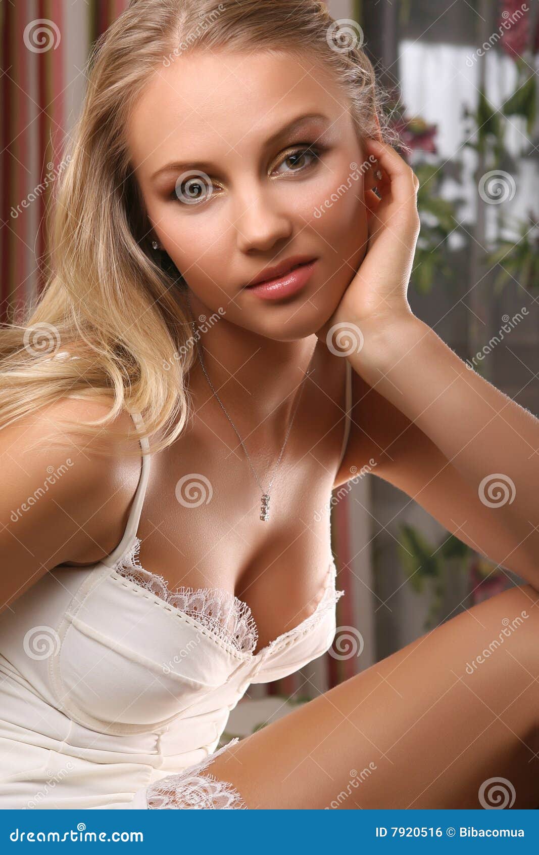 young attractive woman sitting in bedroom