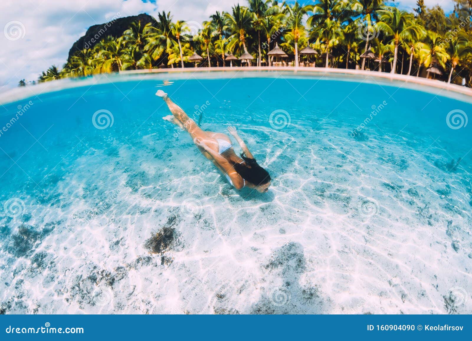 Aerial View Of Young Woman Swimming Underwater In The Pool 
