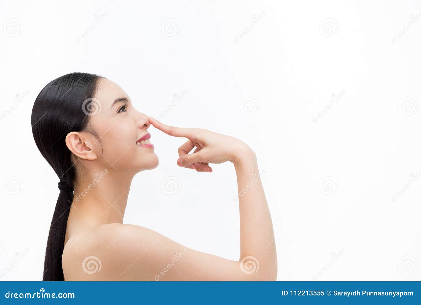 young attractive woman touching her nose with fingertip over  white background