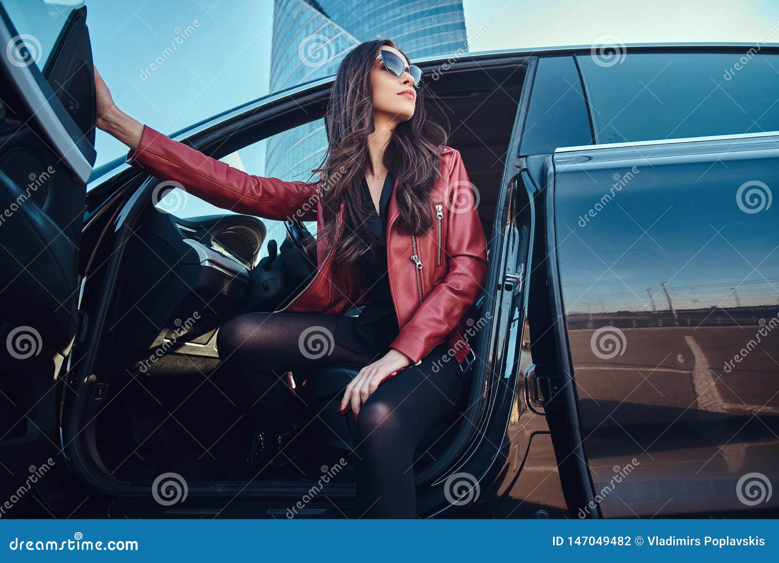 Premium Photo | Young attractive women is posing in her new car. she is  wearing red jacket and sunglasses.