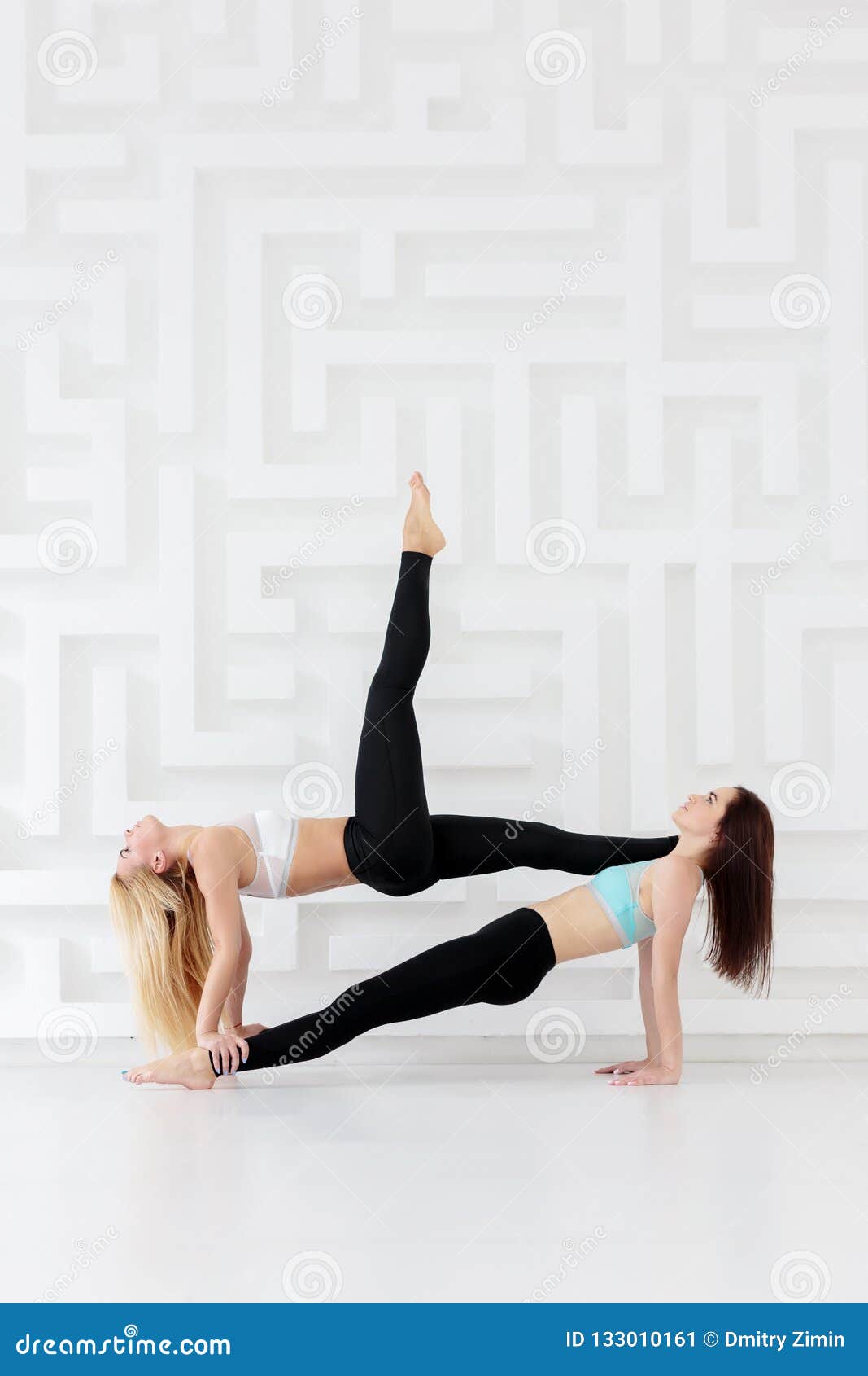 Two Women Doing Acro Yoga Poses At The Gym High-Res Stock Photo - Getty  Images