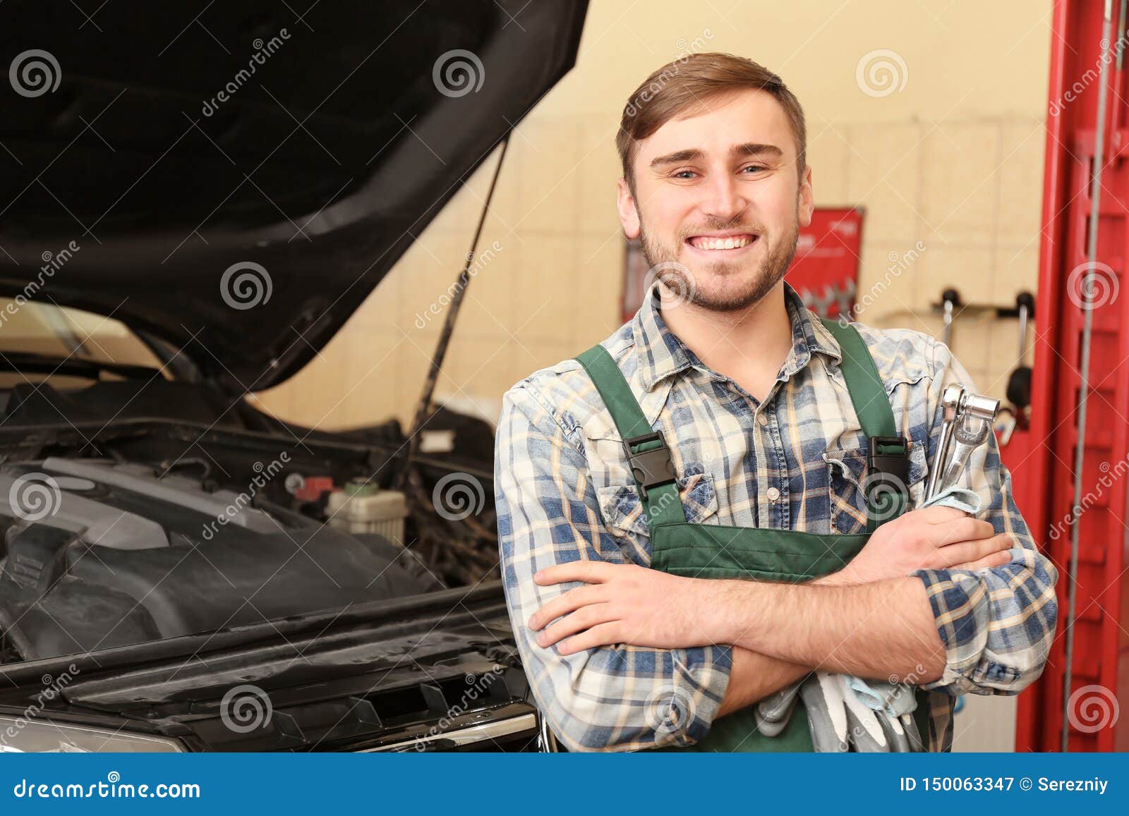 Young Auto Mechanic with Tools Near Car in Service Center Stock Image