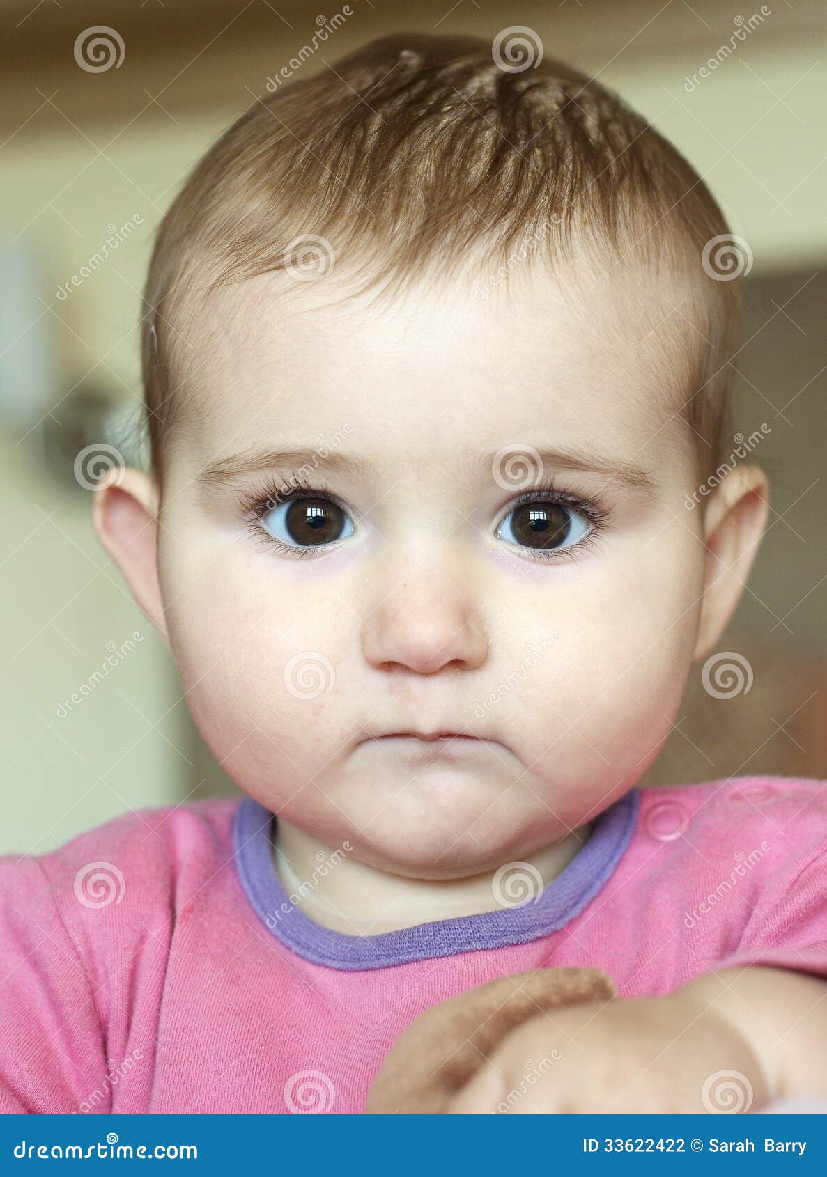 Young Baby Head And Shoulders Shot With Great Expression On Her
