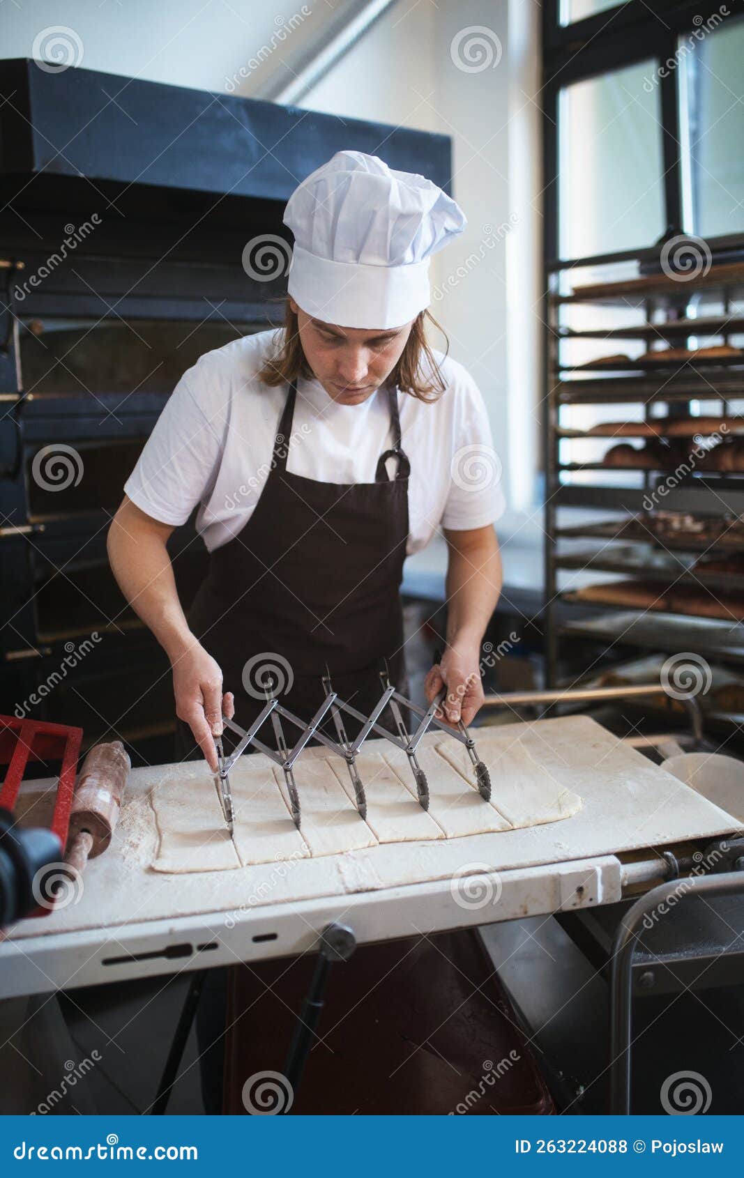 Young Baker Preparing Pastries in Bakery. Stock Photo Image of group