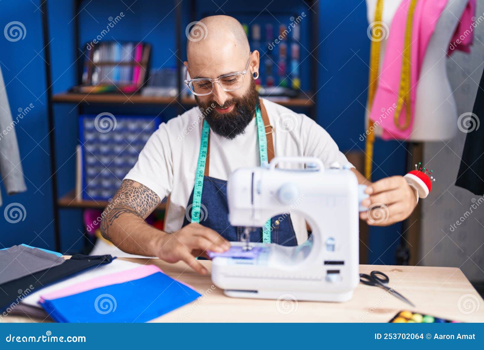 Young Bald Man Tailor Smiling Confident Using Sewing Machine at