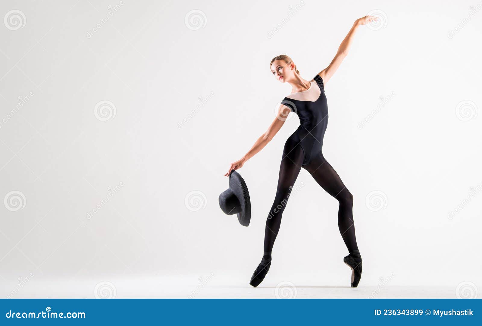 Young Ballerina in Black Pointe Shoes and Black Bondage Costume Posing on  White Background with Hat in Hand Stock Image - Image of copy, dancing:  236343899