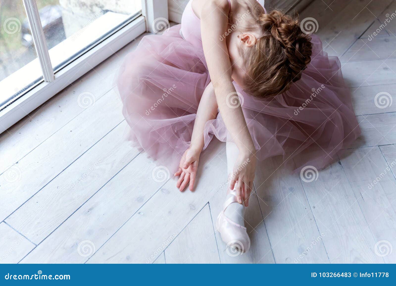 young ballet-dancer sitting on the floor