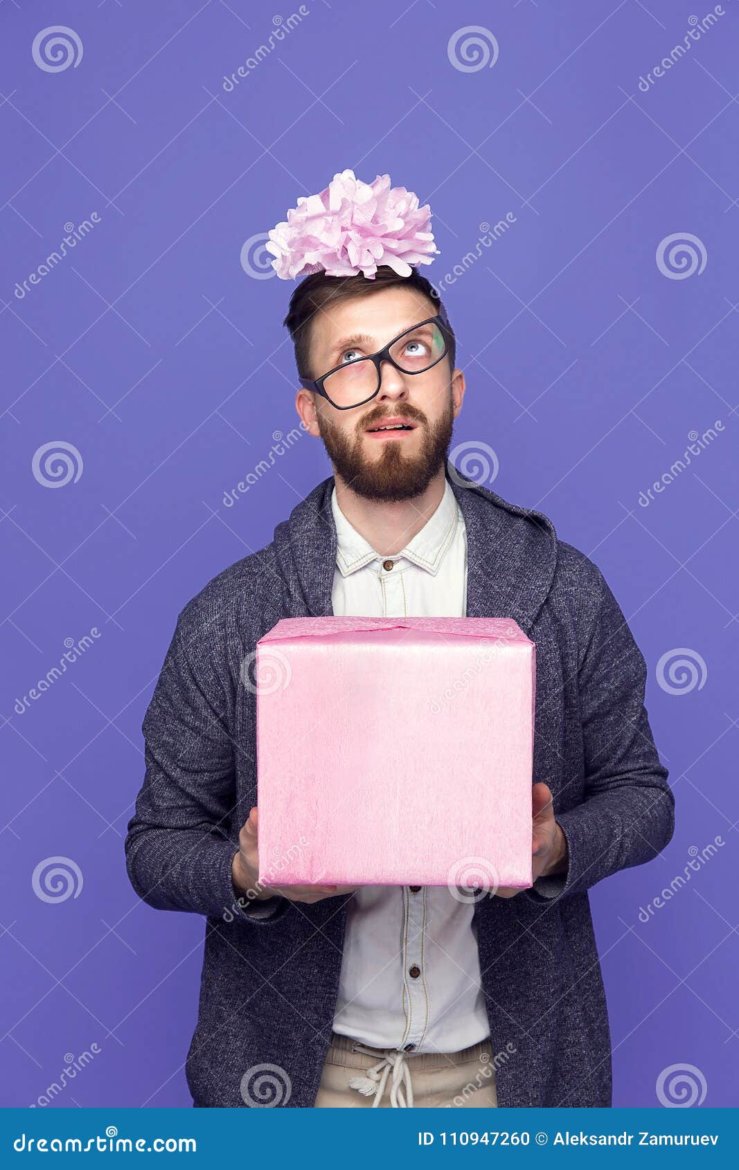 stunned man with pink wrapped present