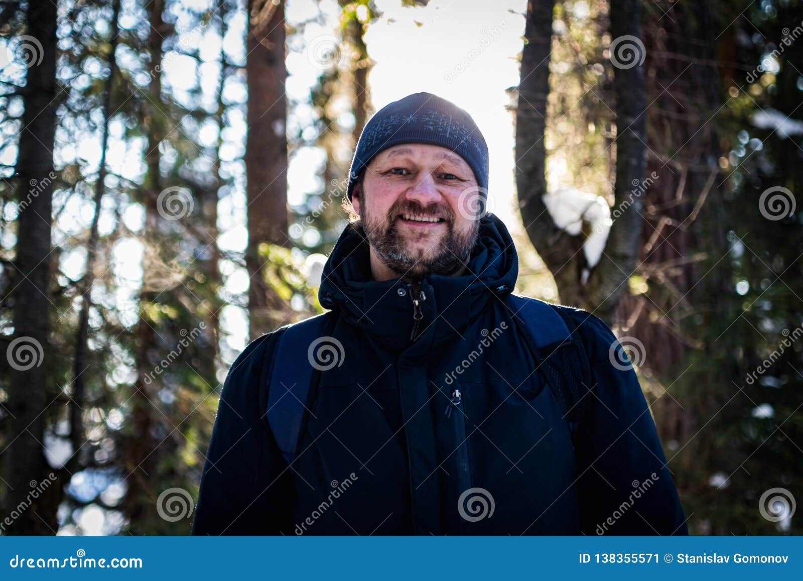 A Young Bearded Man Walks through the Forest and Smiles Looking at You ...