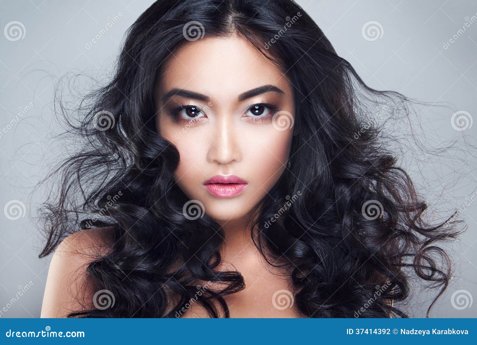 young and beautiful asian woman with curly hair