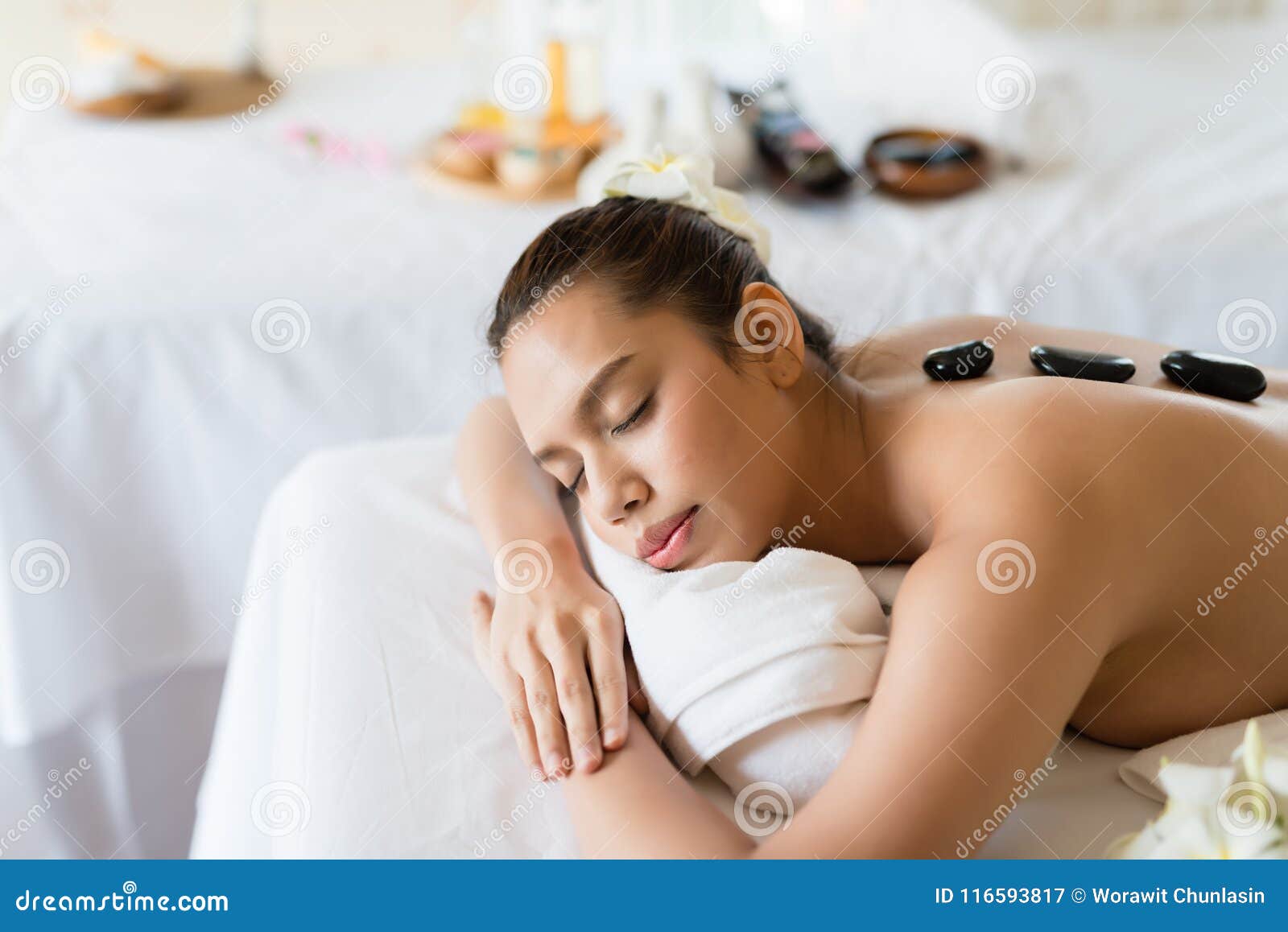 Young Beautiful Asian Woman Relaxing In The Spa Stone Mass