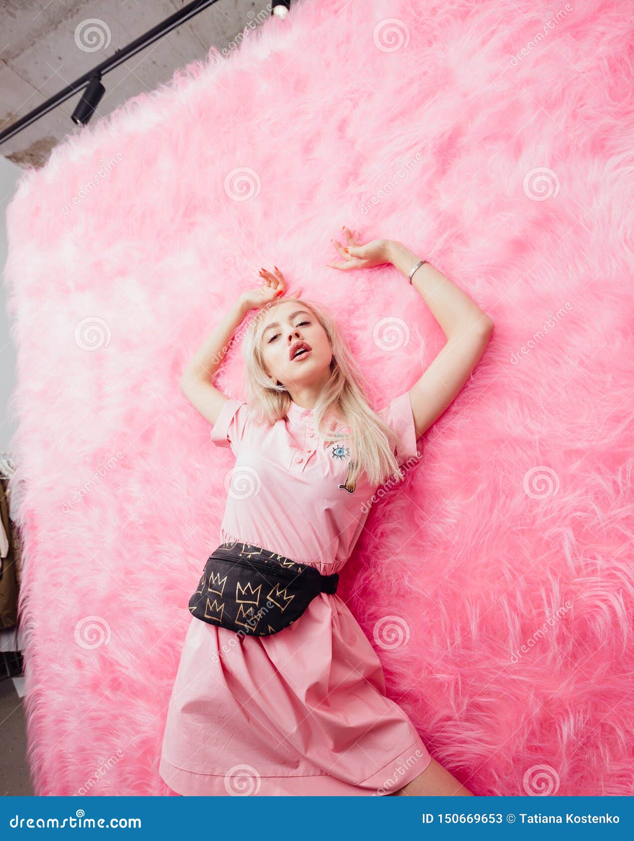 Young Beautiful Blonde Girl Dressed In Fashion Pink Dress Poses On The 