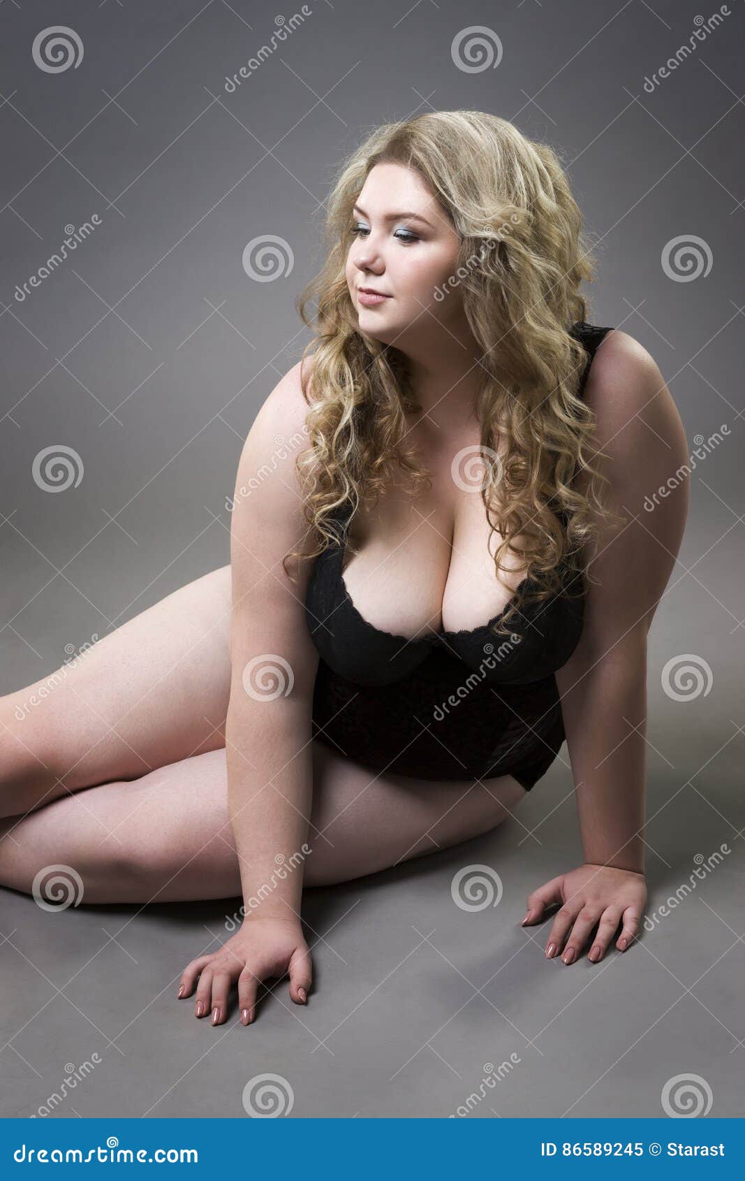 Young Beautiful Blonde Plus Size Model with Big Natural Breasts in Underwear, Xxl Woman on Gray Studio Background Stock Image