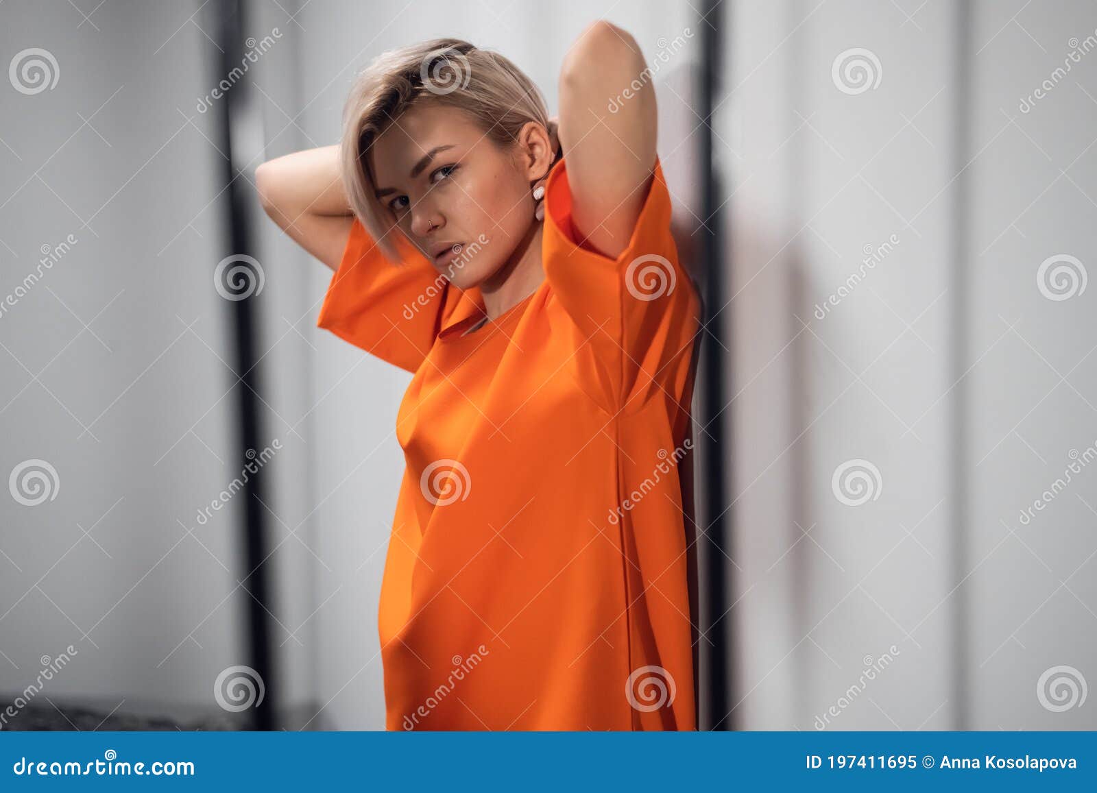 Blonde Inmate In An Asian Women`s General Security Prison Is Led Out Of Her Cell By A Uniformed