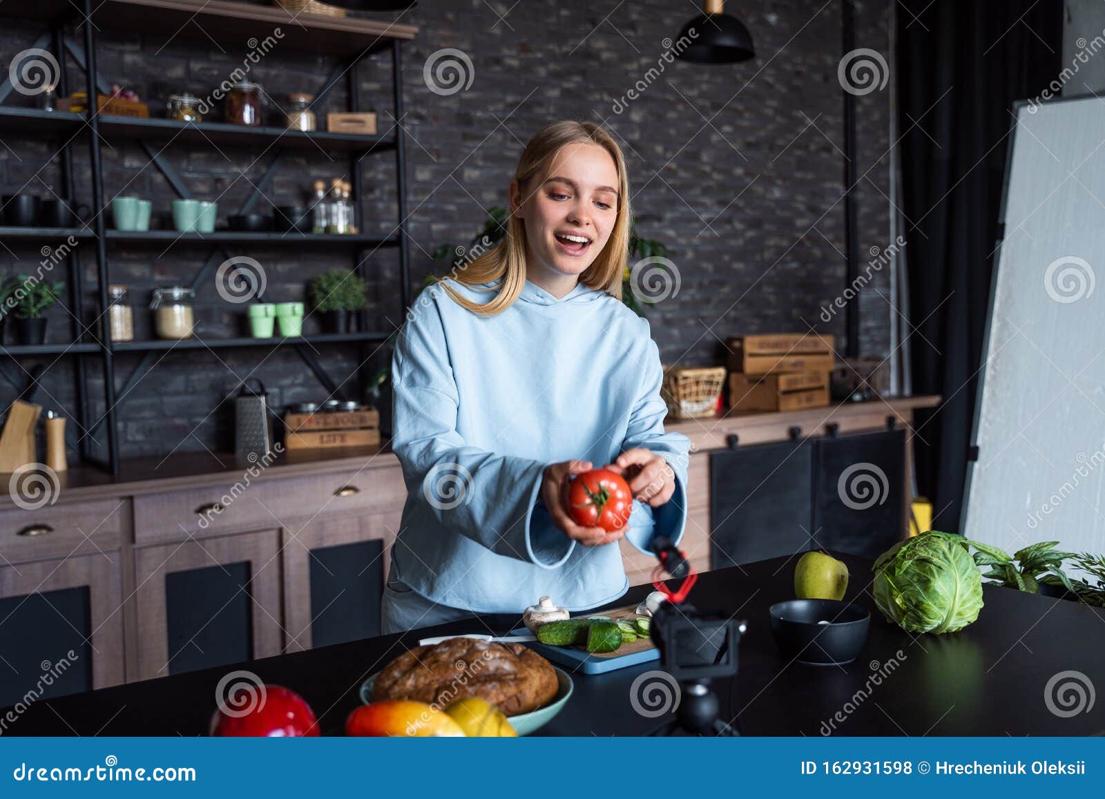 Young Beautiful Blonde Takes On Videos As She Cooks In The Kitch