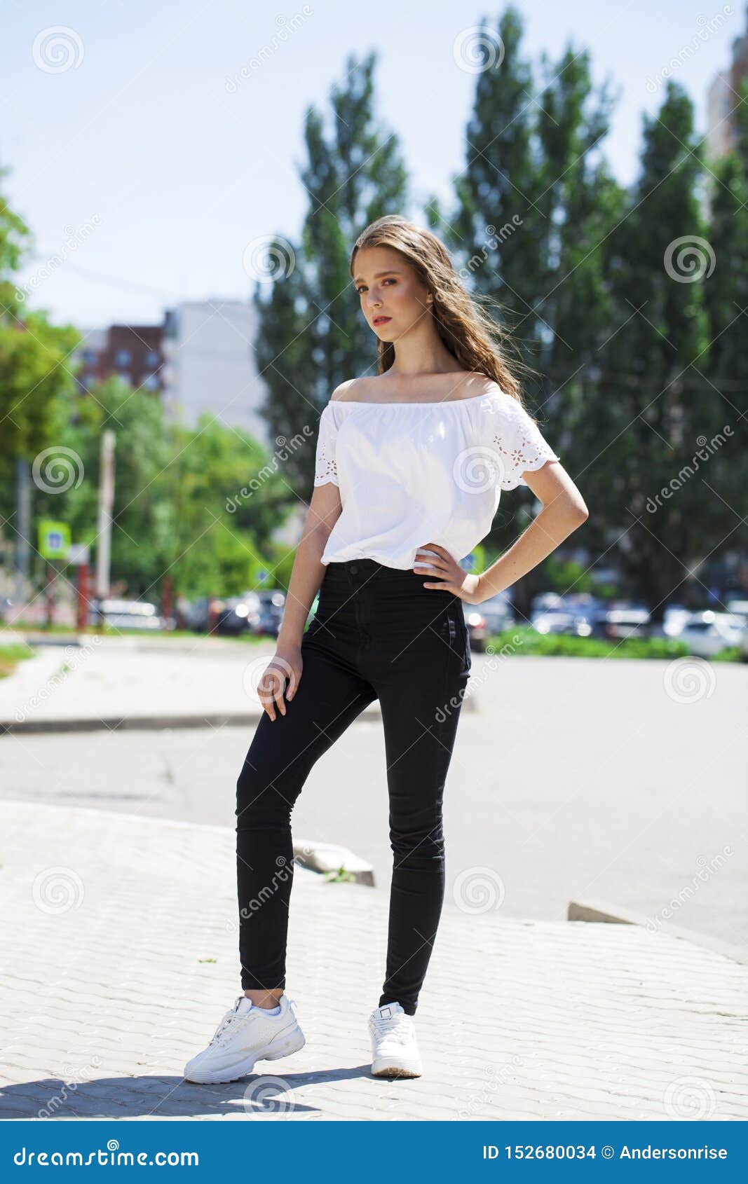 Young Beautiful Brunette Woman in Jeans and White Blouse Walking in ...