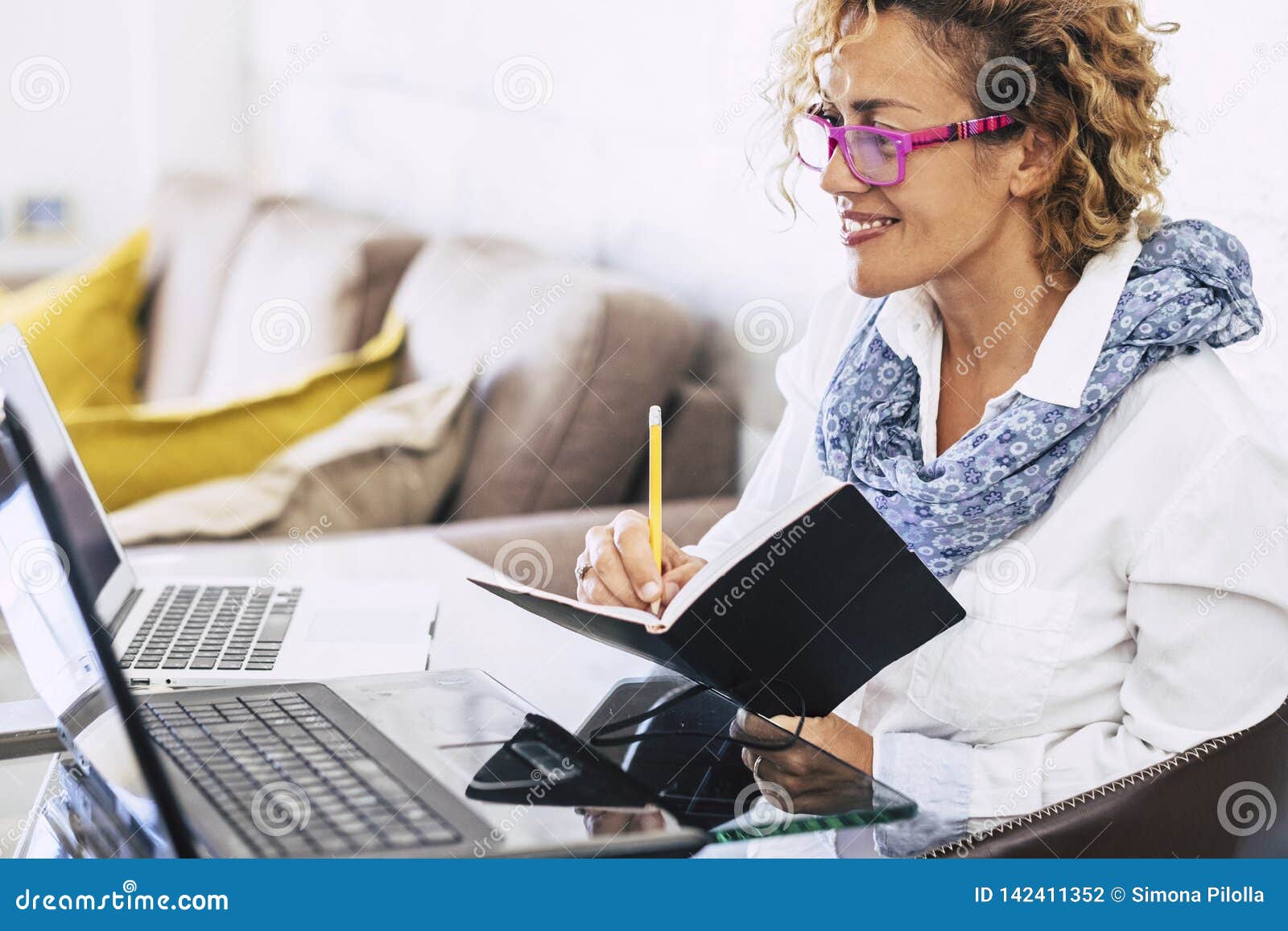 young beautiful business woman smile and work with two different laptop - modern alternative office at home for independent people