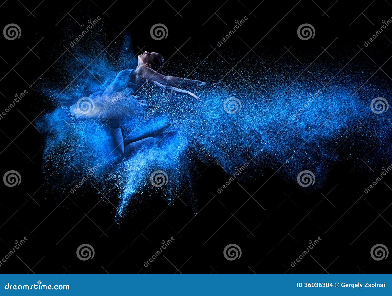 young beautiful dancer jumping into blue powder cloud