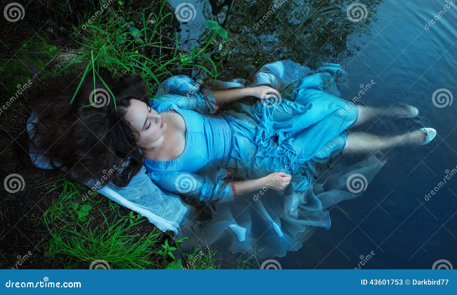 young beautiful drowned woman lying in the water