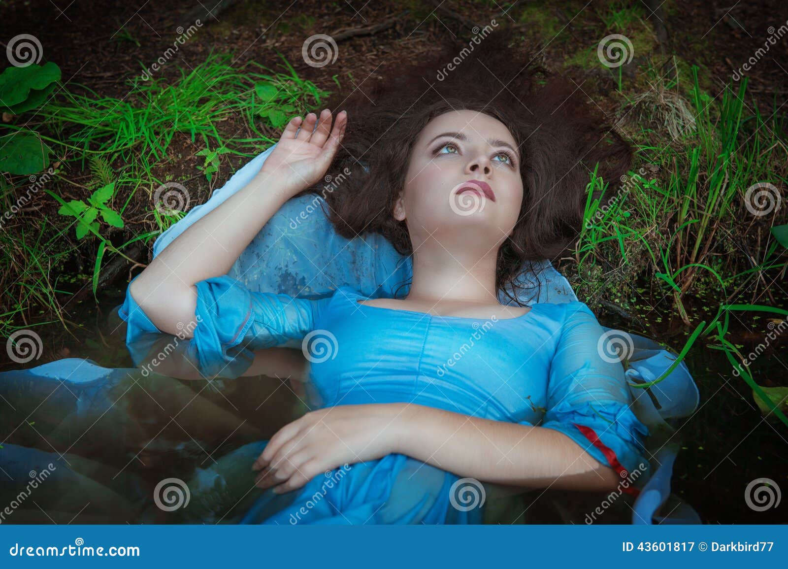 young beautiful drowned woman lying in the water