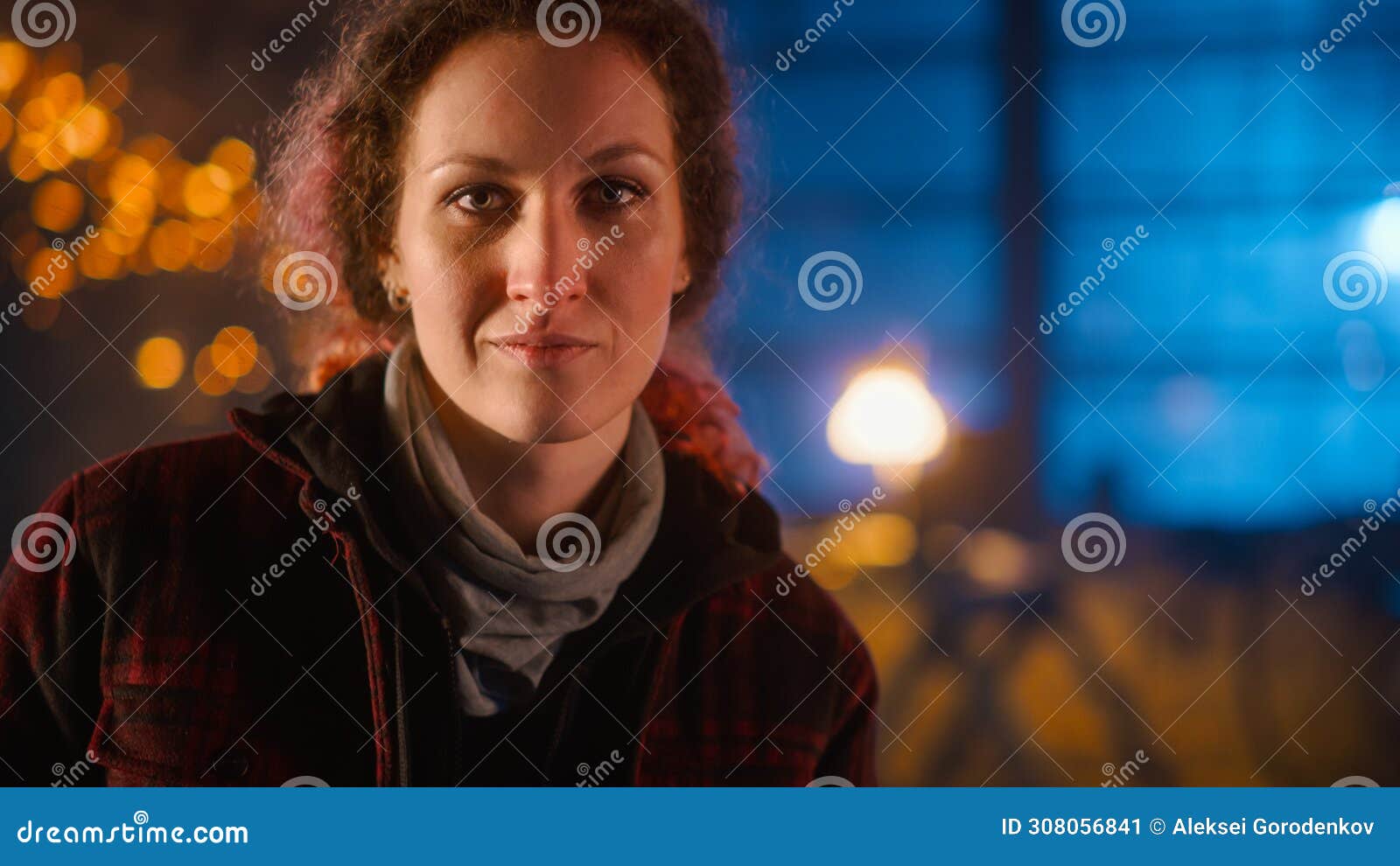 young beautiful empowering woman gently smiles at the camera. authentic fabricator wearing work cl