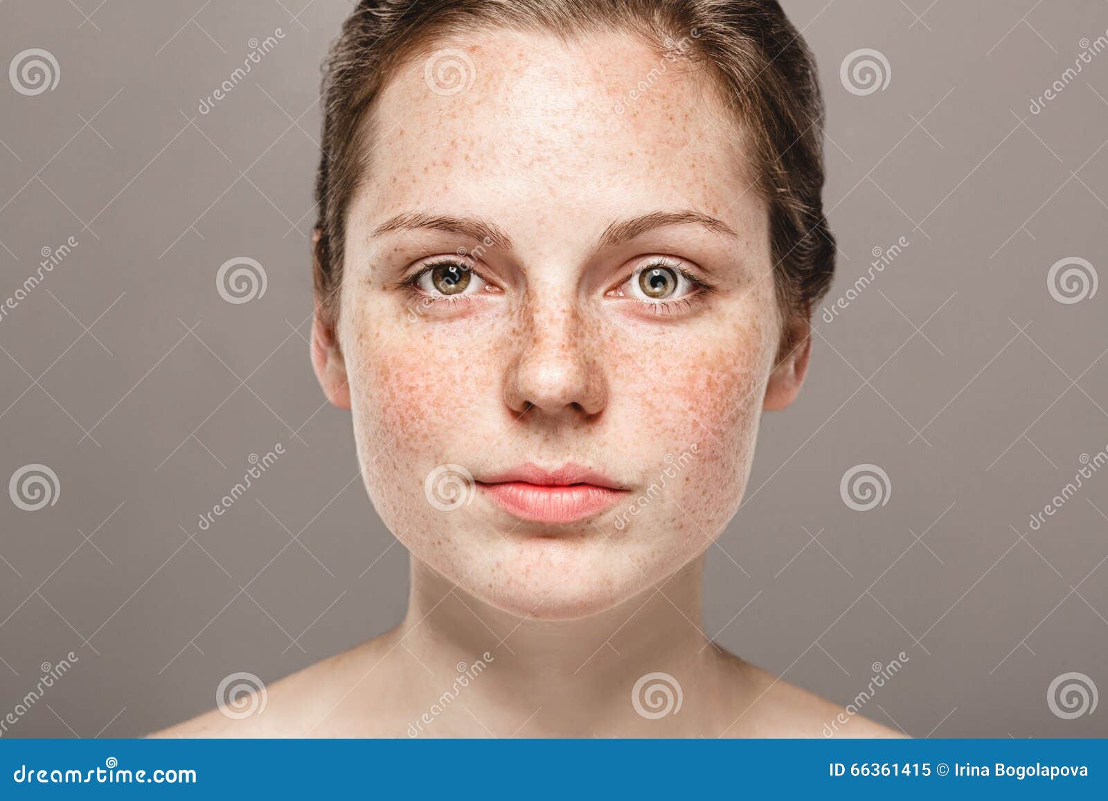young beautiful freckles woman face portrait with healthy skin