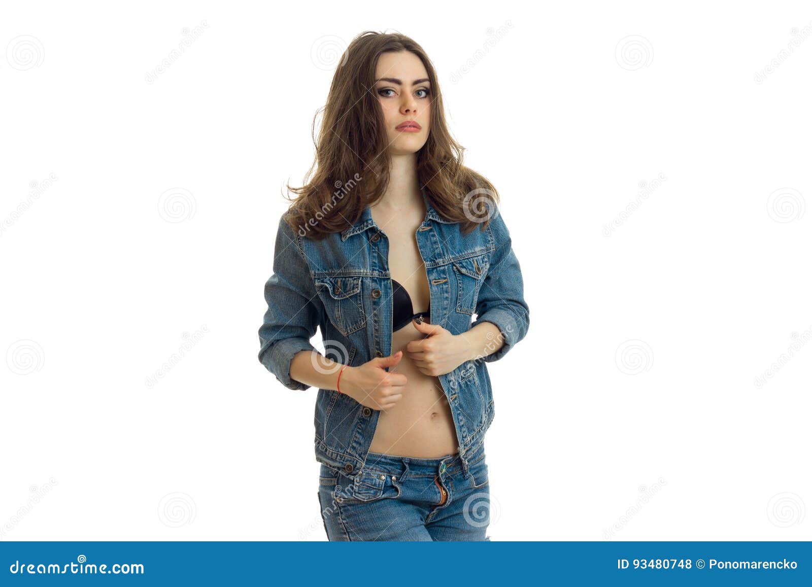 young beautiful happy stylish hipster girl in a denim jacket and shorts  posing on a light background Stock Photo - Alamy