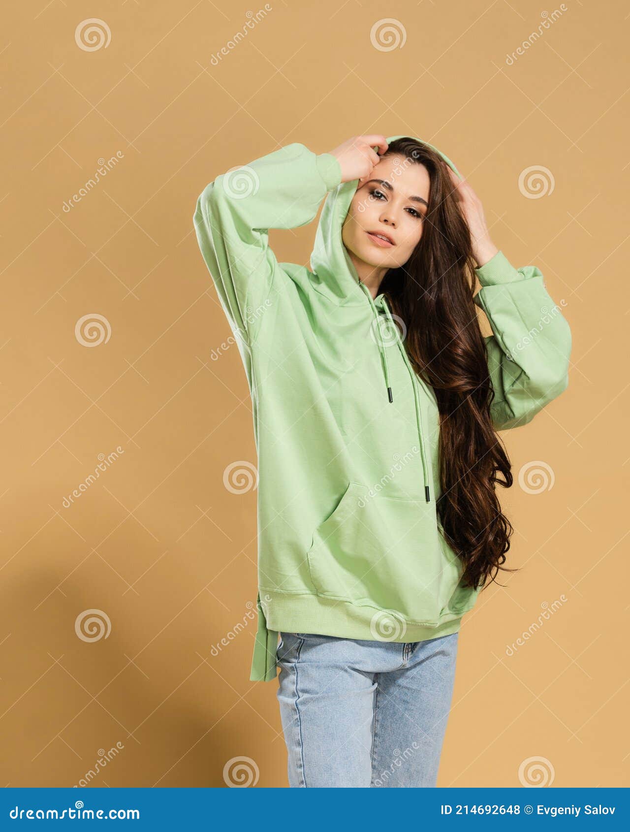 Young Beautiful Girl with Long Hair in a Pistachio-colored Hoodie ...