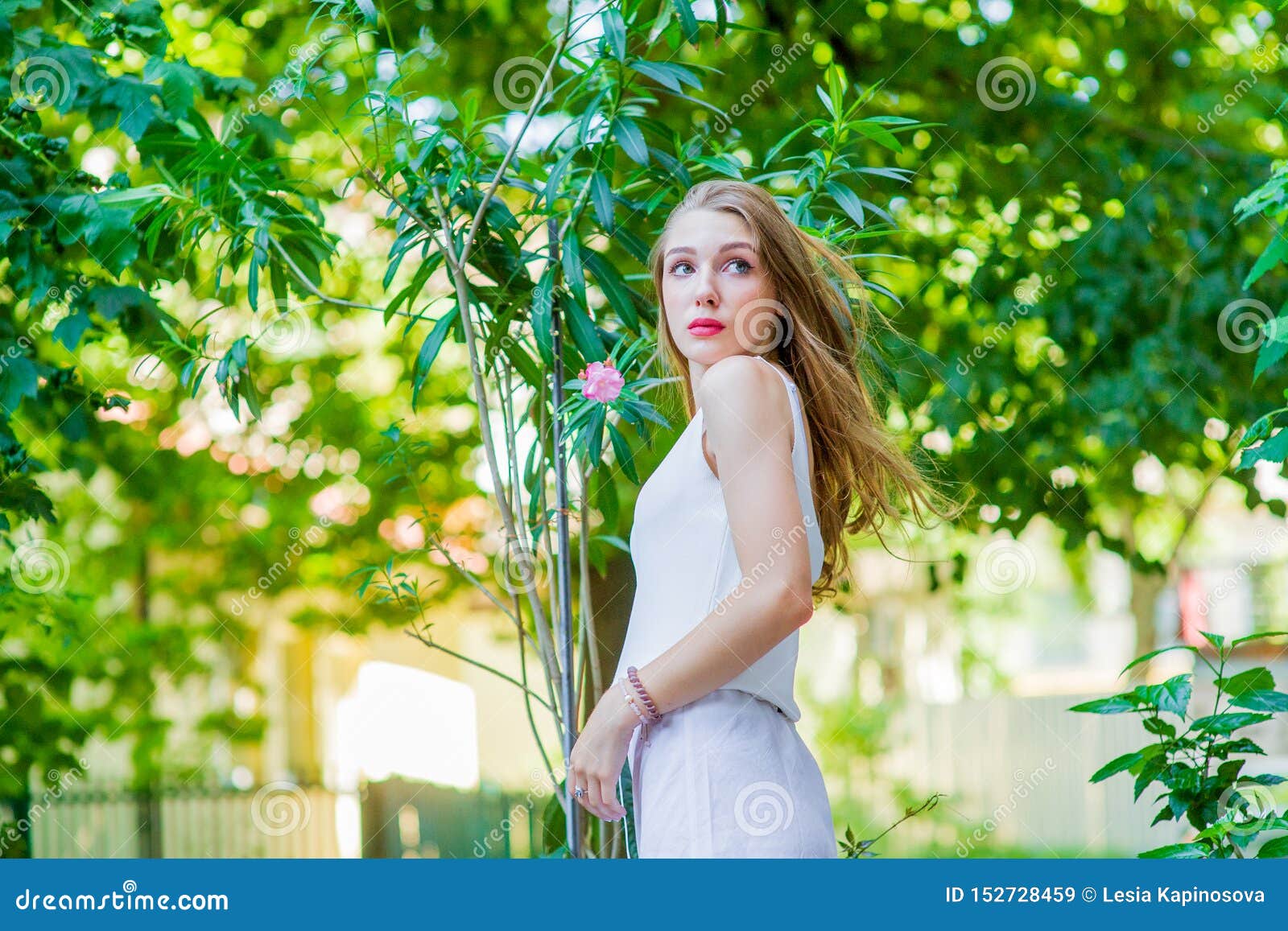 Young Beautiful Girl Posing Outdoor Wearing Fashionable White Dress