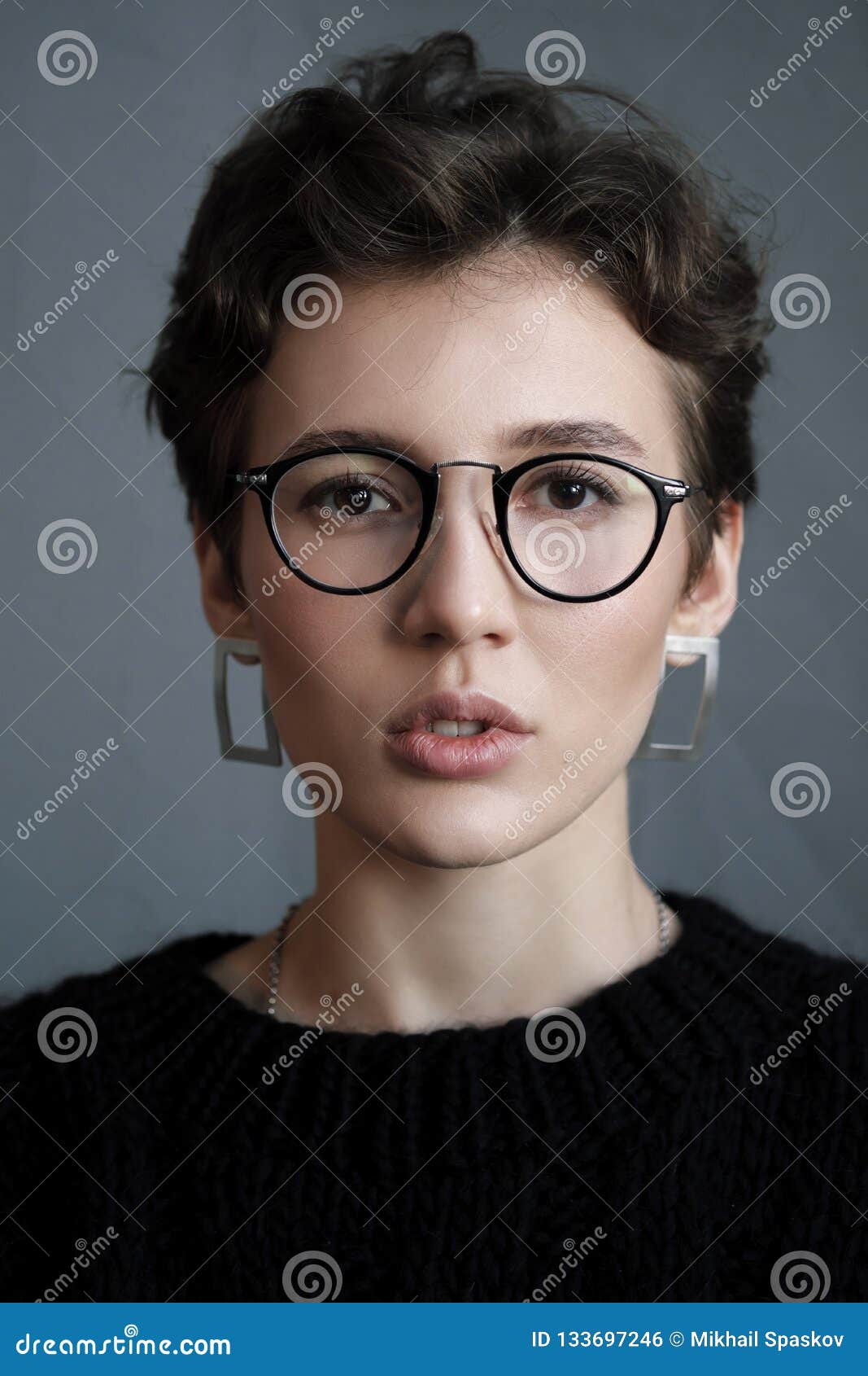 Young Beautiful Girl with Short Curly Hair in Glasses and Black Casual  Clothes, Studio Portrait. Stock Photo - Image of friendly, eyeglasses:  133697246