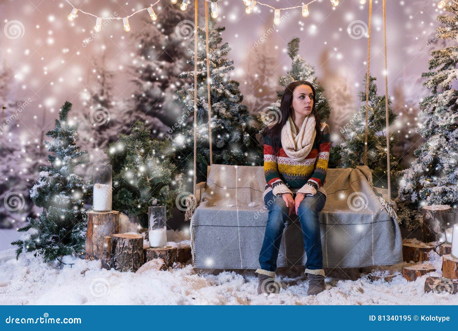 Young Beautiful Girl Sitting on a Bench or a Swing in a Snow-covered ...