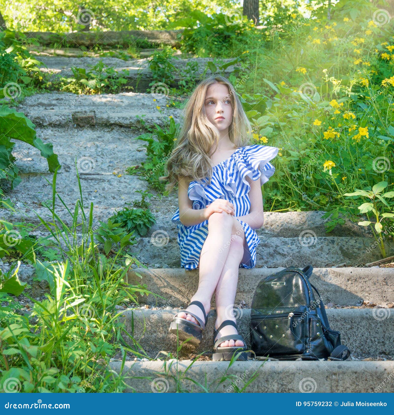 Young Beautiful Girl Sitting on the Stairs in the Park with Flower ...